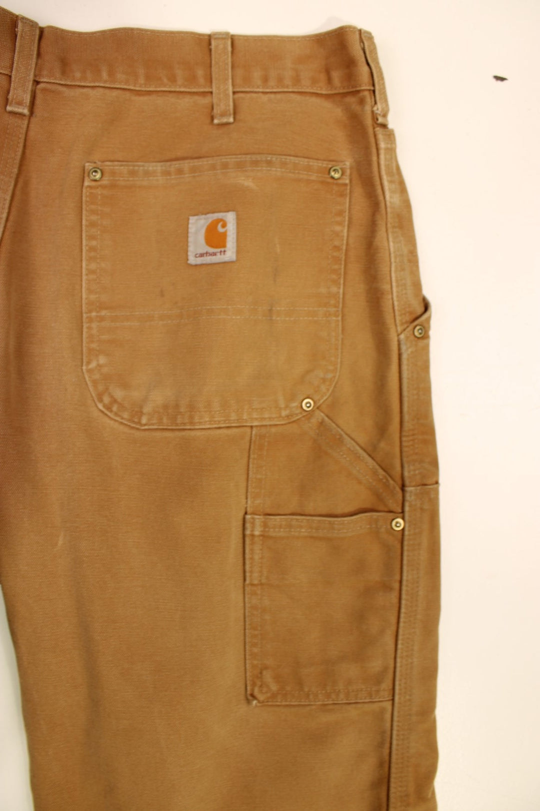 Carhartt Double Knee Jeans in a brown colourway with multiple pockets and the logo embroidered on the back.