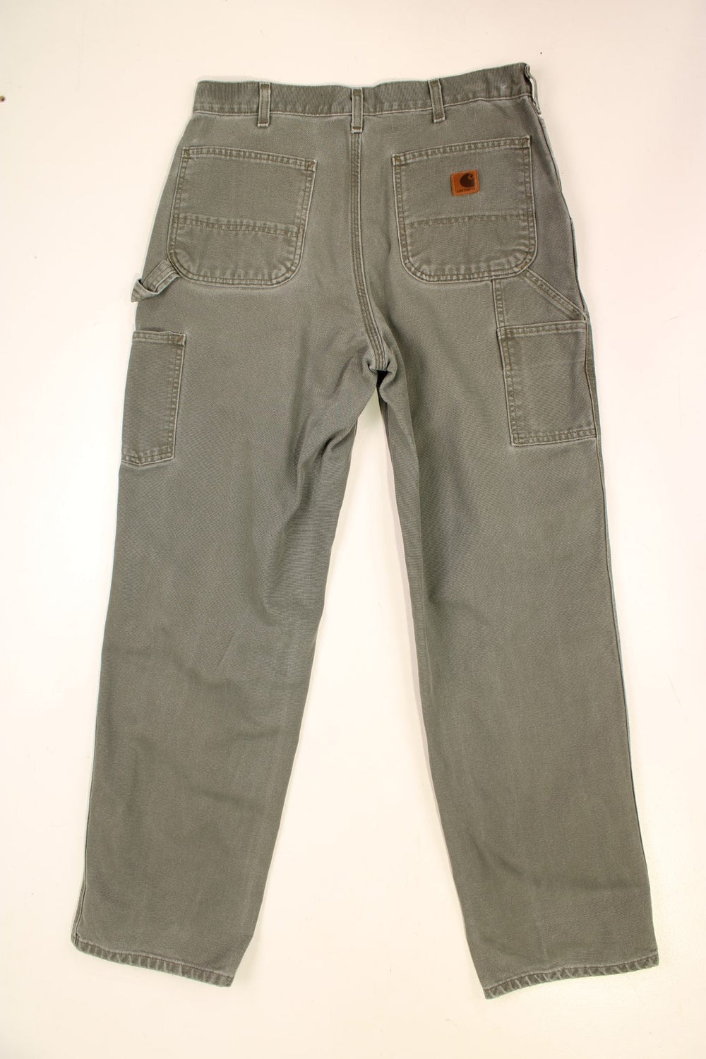 Carhartt Carpenter Jeans in a green colourway with multiple pockets and the logo embroidered on the back.