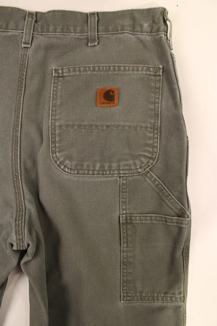 Carhartt Carpenter Jeans in a green colourway with multiple pockets and the logo embroidered on the back.