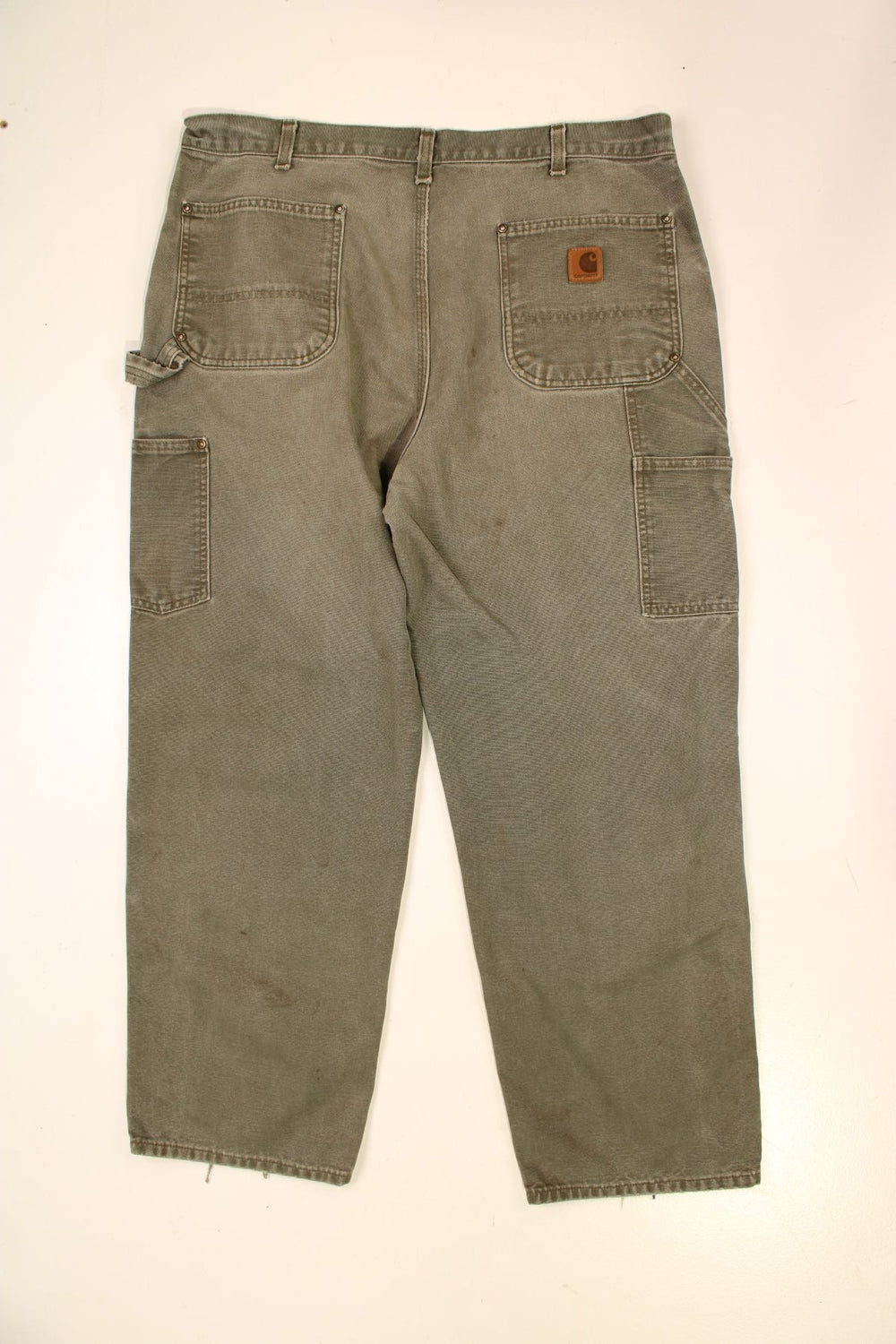 Carhartt Double Knee Jeans in a green colourway with multiple pockets and the logo embroidered on the back.