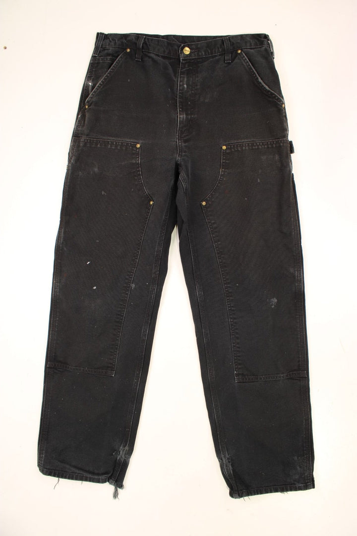 Carhartt Double Knee Jeans in a black colourway with multiple pockets and the logo embroidered on the back.