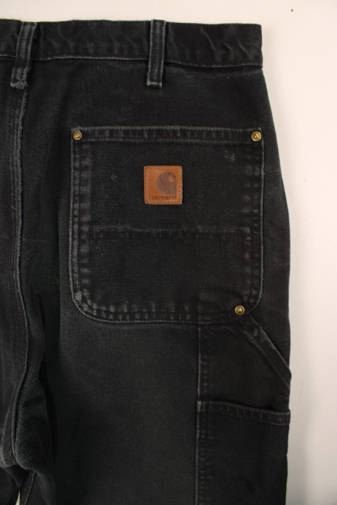 Carhartt Double Knee Jeans in a black colourway with multiple pockets and the logo embroidered on the back.