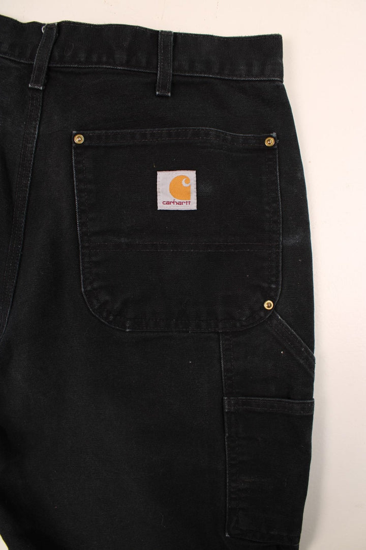 Carhartt Double Knee Jeans in a black colourway with multiple pockets and the logo embroidered on the back.