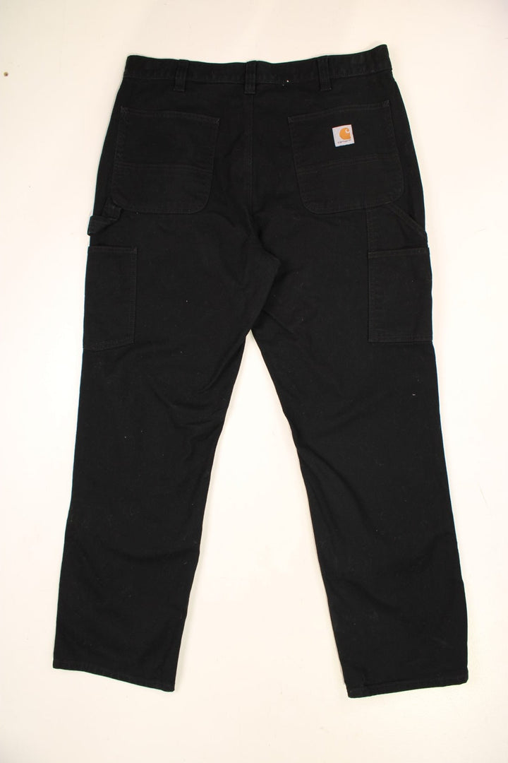 Carhartt Double Knee Jeans in a black colourway with multiple pockets and the logo embroidered on the back.