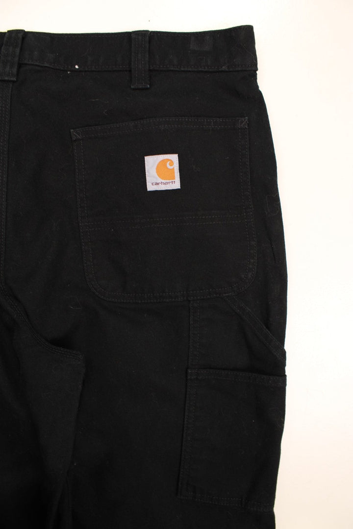 Carhartt Double Knee Jeans in a black colourway with multiple pockets and the logo embroidered on the back.