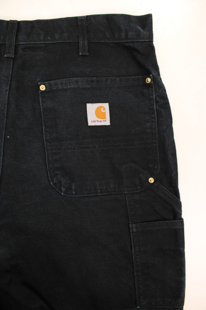 Carhartt Double Knee Jeans in a black colourway with multiple pockets and the logo embroidered on the back.