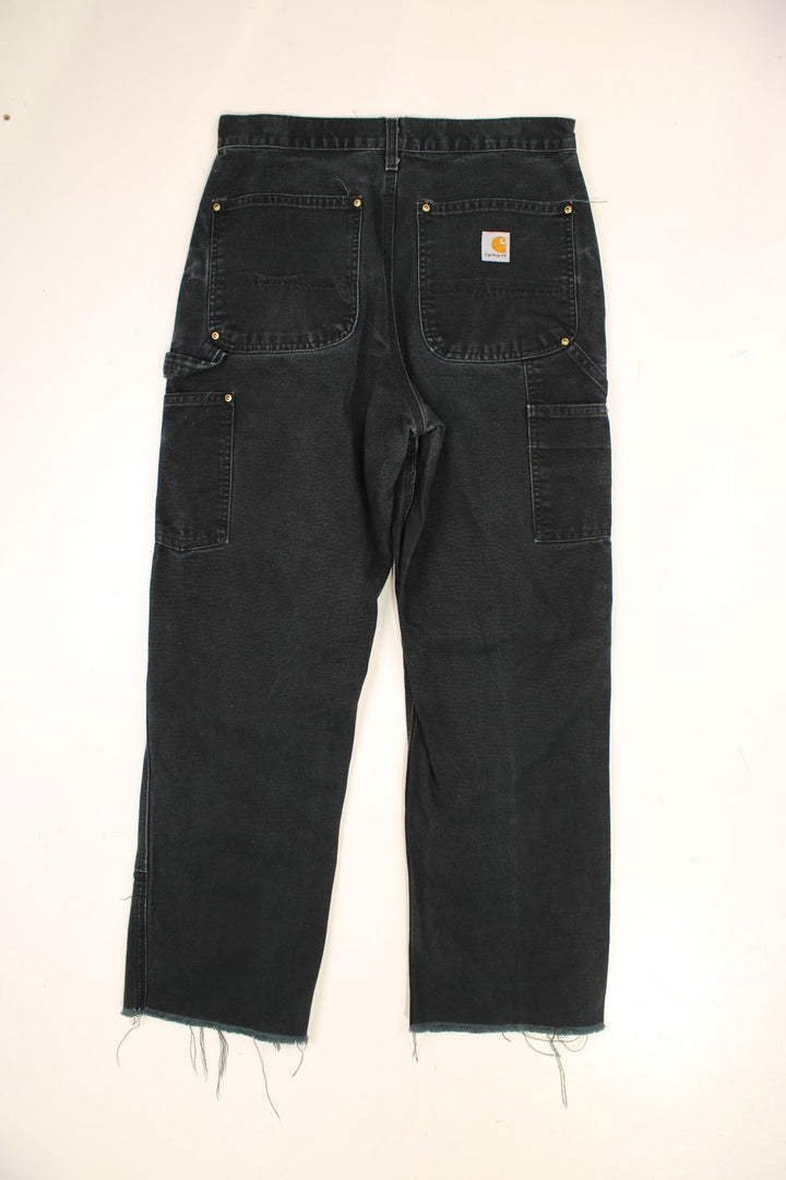 Carhartt Double Knee Jeans in a black colourway with multiple pockets and the logo embroidered on the back.