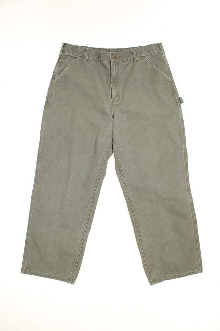 Carhartt Carpenter Jeans in a khaki green colourway, has multiple pockets and the logo embroidered on the back. 