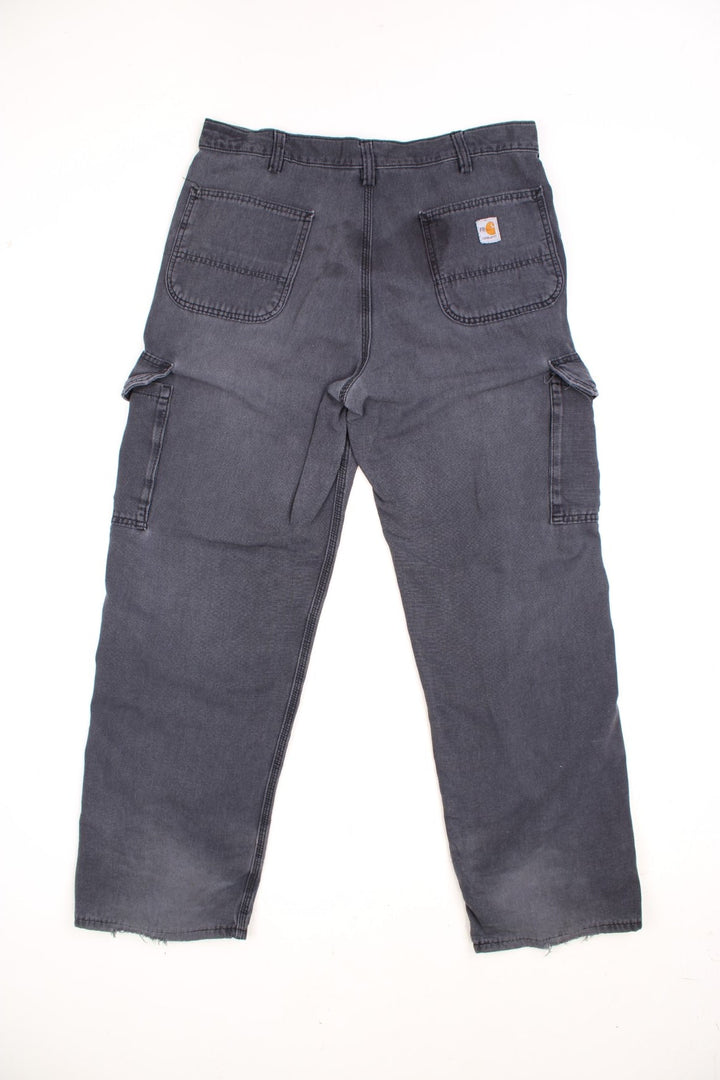 Carhartt Cargo Trousers in a faded grey colourway, has multiple pockets and the logo embroidered on the back.