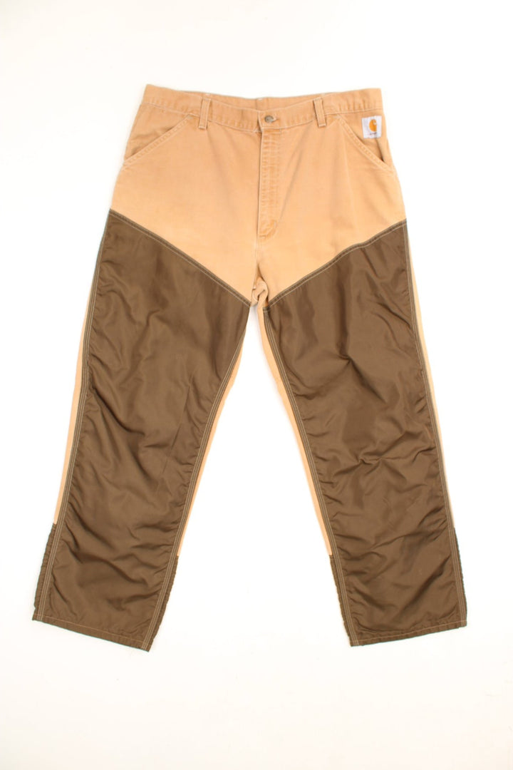 Carhartt Canvas Double Knee Jeans in a brown colourway with nylon canvas double knees, has multiple pockets and the logo embroidered on the front. 