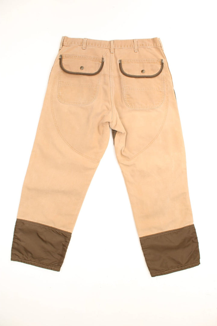 Carhartt Canvas Double Knee Jeans in a brown colourway with nylon canvas double knees, has multiple pockets and the logo embroidered on the front. 