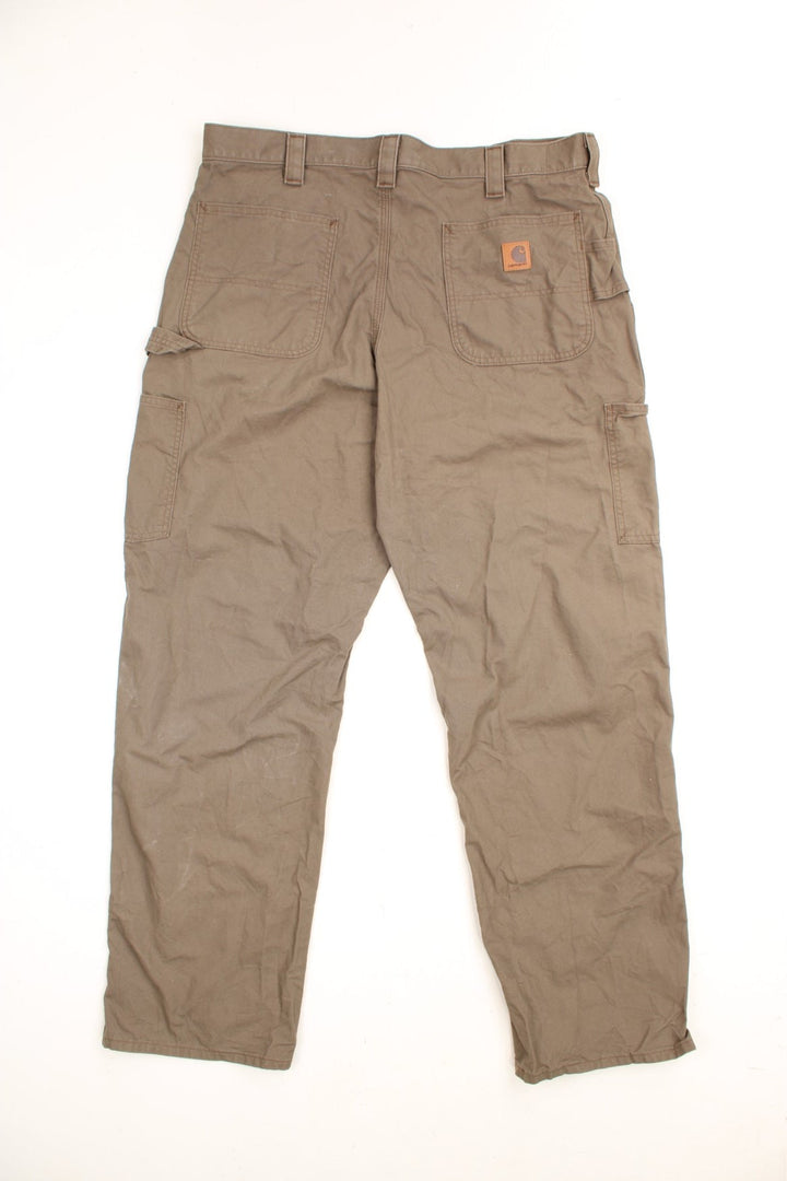 Carhartt Carpenter Trousers in a brown colourway, loose fit, has multiple pockets and the logo embroidered on the back.