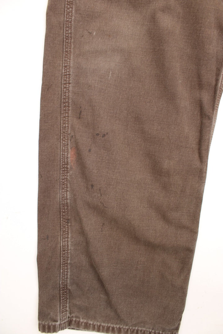 Carhartt Carpenter Jeans in a faded brown colourway, has multiple pockets and the logo embroidered on the back. 