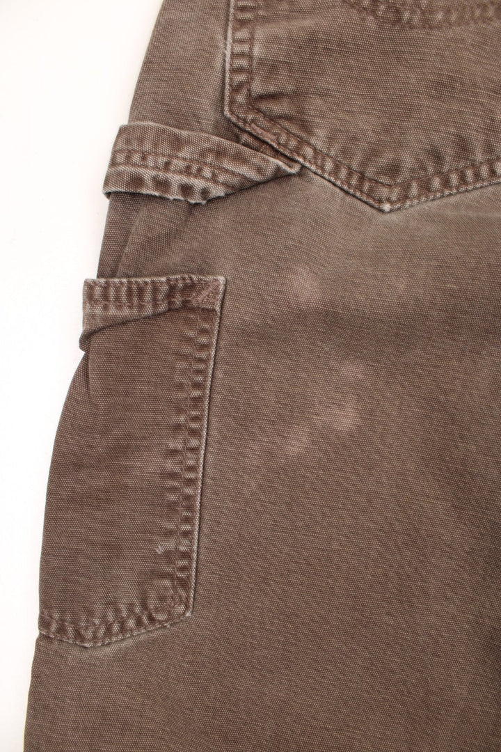 Carhartt Carpenter Jeans in a faded brown colourway, has multiple pockets and the logo embroidered on the back. 