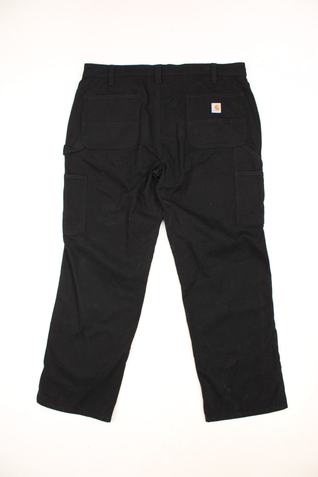 Carhartt black carpenter jeans with front, back and side pockets, a hammer loop, and a logo patch on the back pocket. 