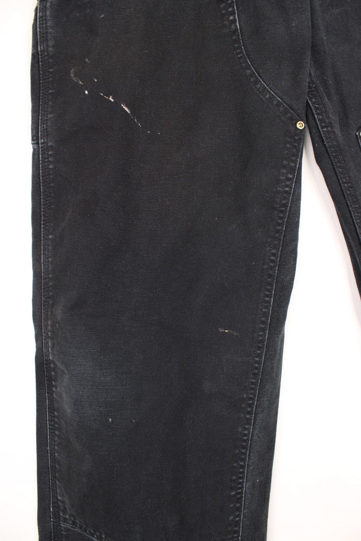 Carhartt double knee jeans with front, back and side pockets, a hammer loop, and a logo patch on the back pocket. 