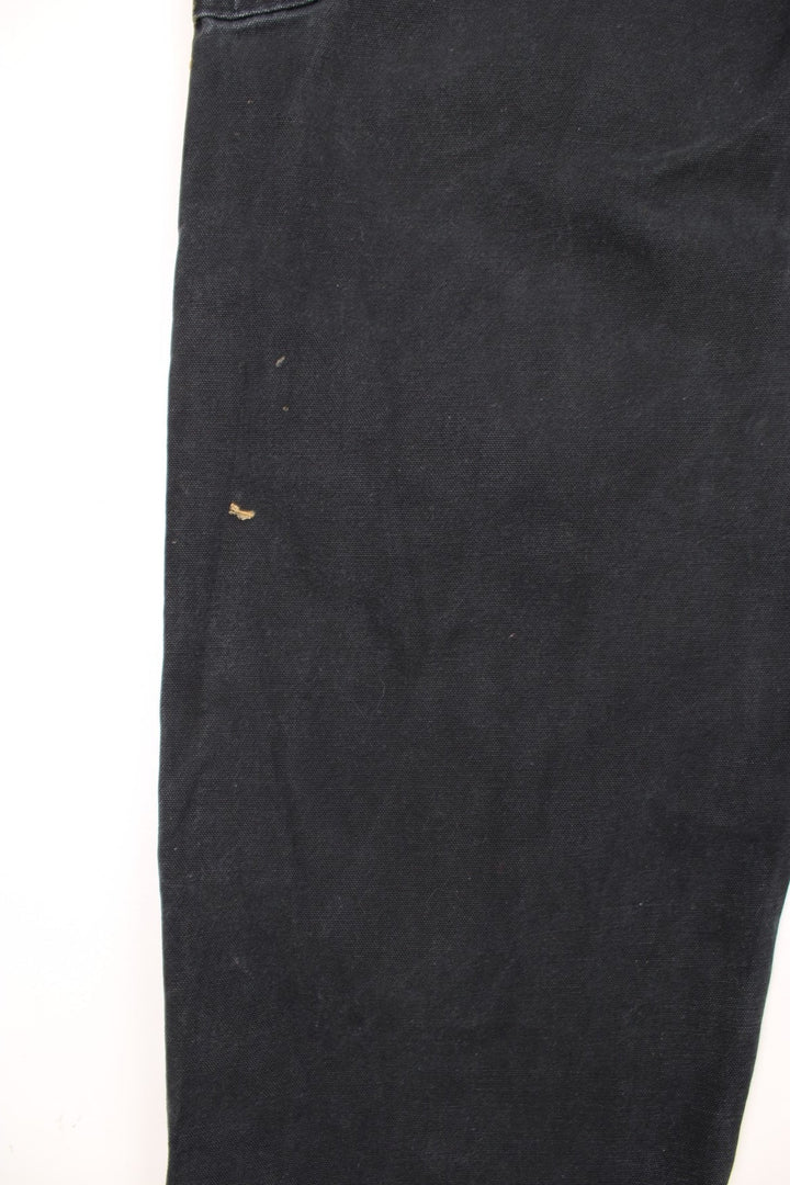 Carhartt double knee jeans with front, back and side pockets, a hammer loop, and a logo patch on the back pocket. 