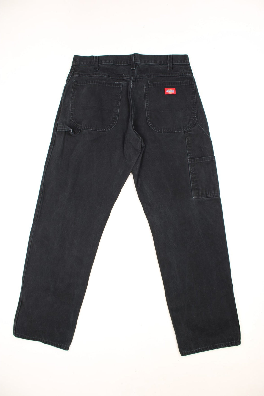 Dickies black carpenter jeans with front, back and side pockets, a hammer loop, and a logo patch on the back pocket. 