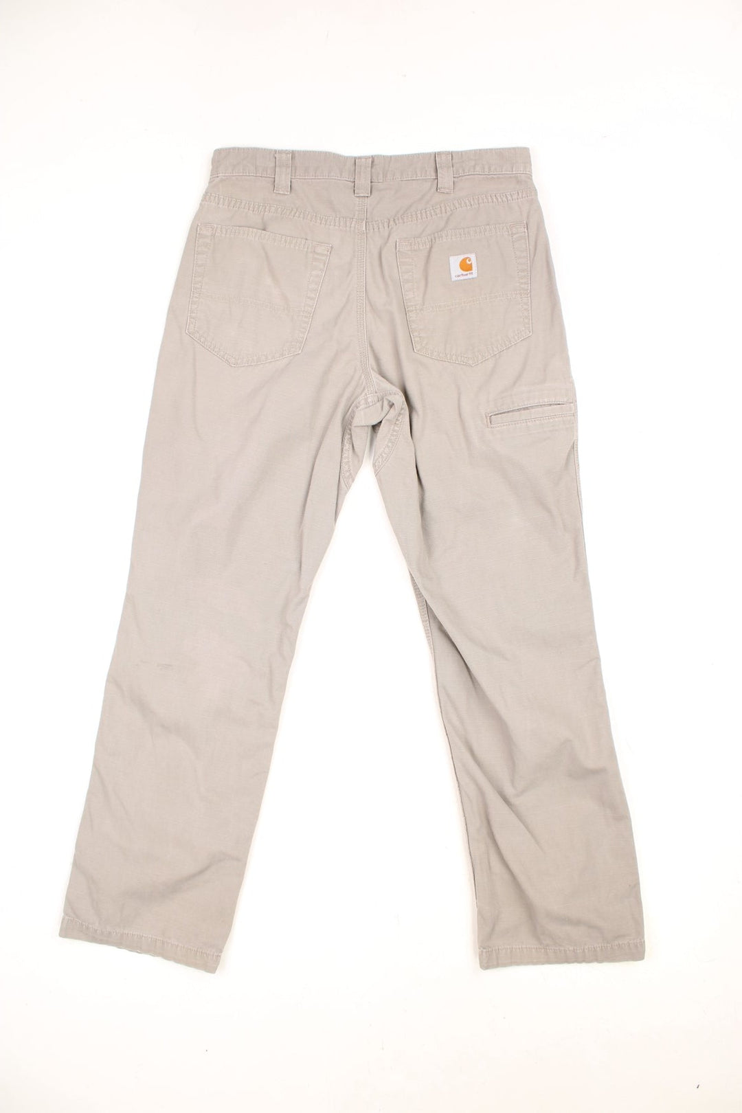 Carhartt grey-beige trousers with front, back and side pockets and a logo patch on the back pocket. 