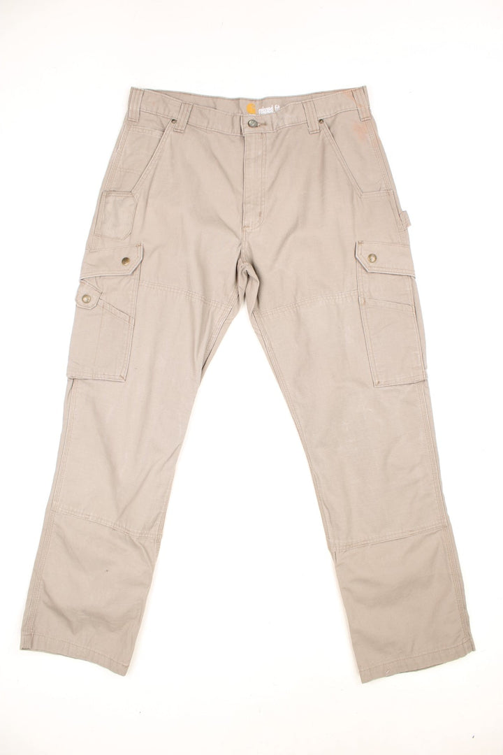 Carhartt tan double knee trousers with a hammer loop, front, back and side pockets and a logo patch on the back pocket. 