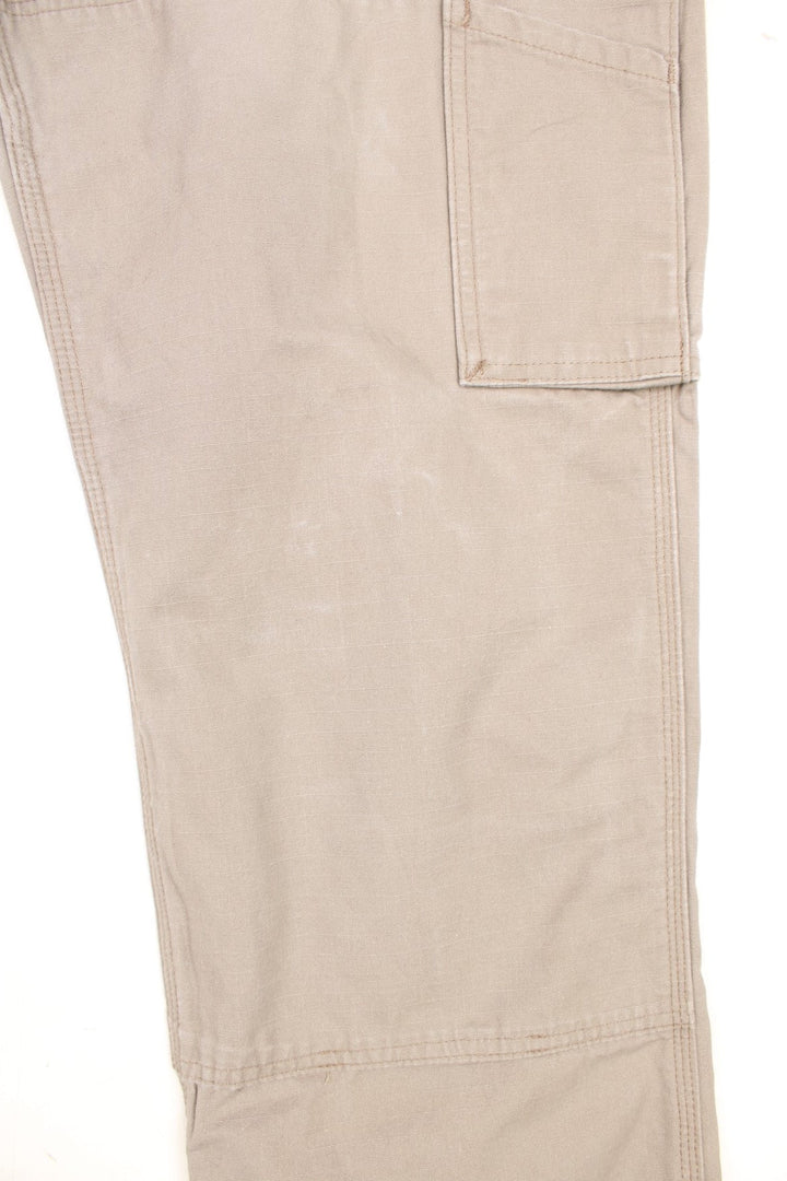 Carhartt tan double knee trousers with a hammer loop, front, back and side pockets and a logo patch on the back pocket. 