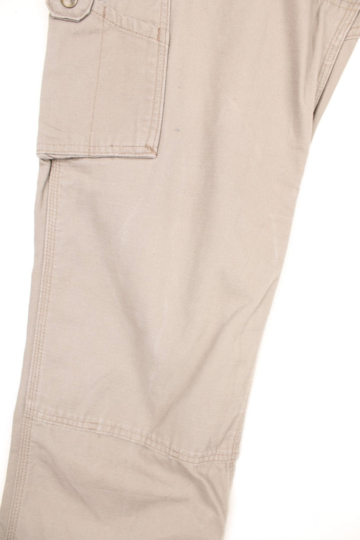 Carhartt tan double knee trousers with a hammer loop, front, back and side pockets and a logo patch on the back pocket. 