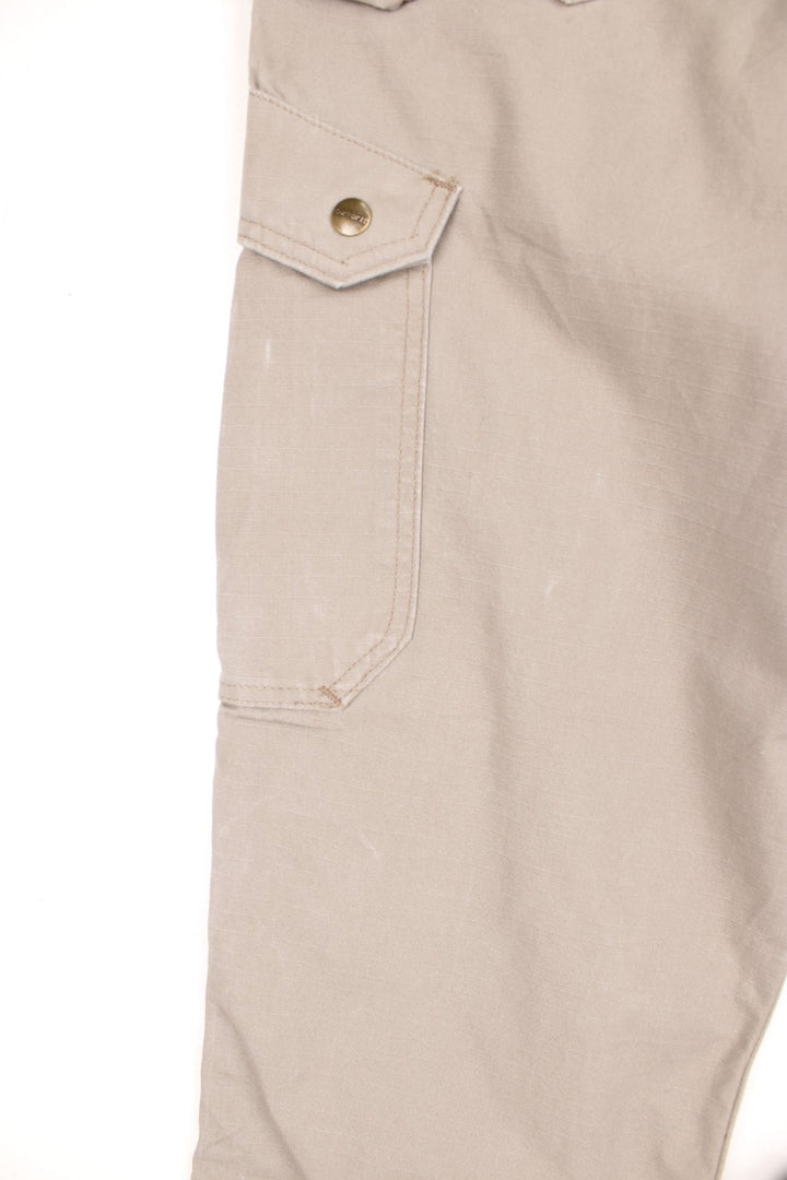 Carhartt tan double knee trousers with a hammer loop, front, back and side pockets and a logo patch on the back pocket. 