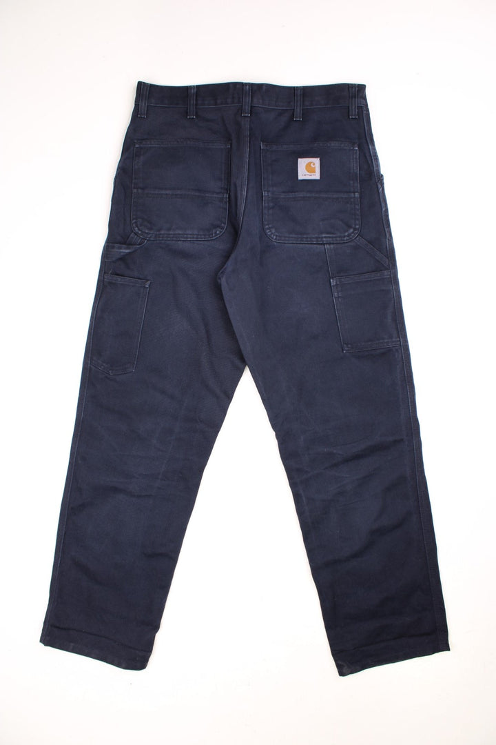 Carhartt WIP Carpenter Jeans in a blue colourway, has multiple pockets and the logo embroidered on the back.