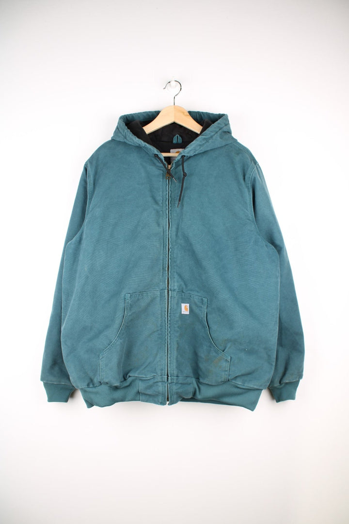  Carhartt Active Hooded Jacket in a teal green colourway. The jacket has two front pockets, a hood and an elasticated cuff on the sleeves and hem.