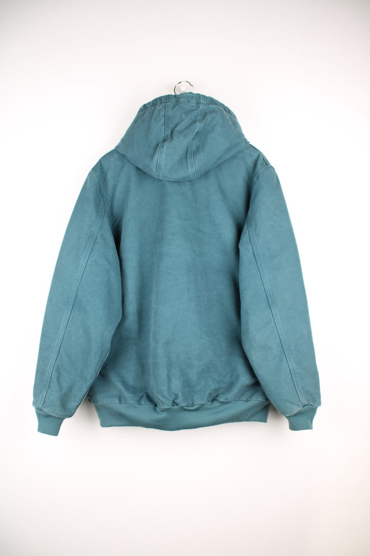  Carhartt Active Hooded Jacket in a teal green colourway. The jacket has two front pockets, a hood and an elasticated cuff on the sleeves and hem.