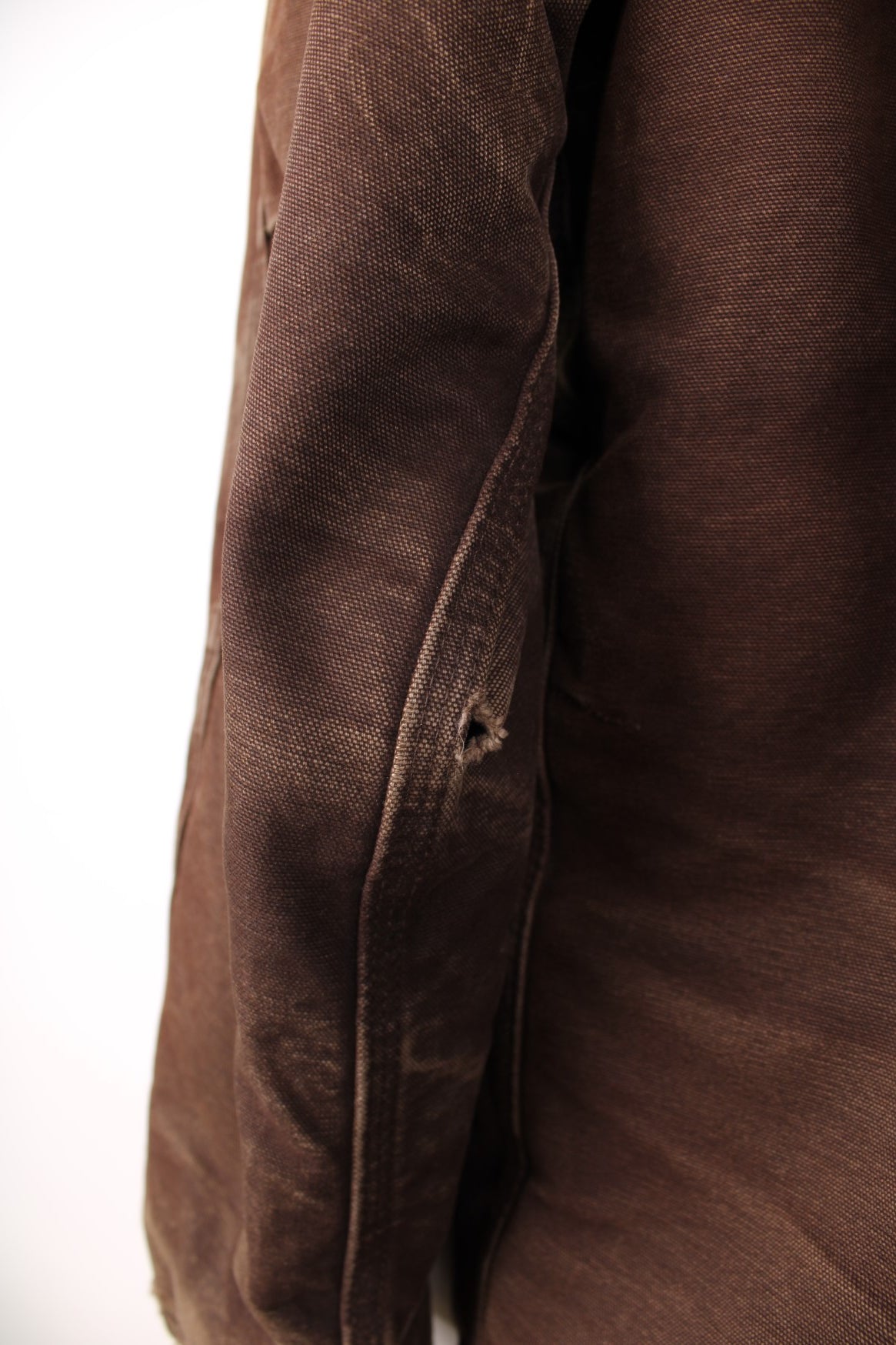 Carhartt Arctic jacket in brown. Quilt lined, with a dark brown corduroy collar,zip and velcro closure, four pockets and a leather logo patch on the upper left.  