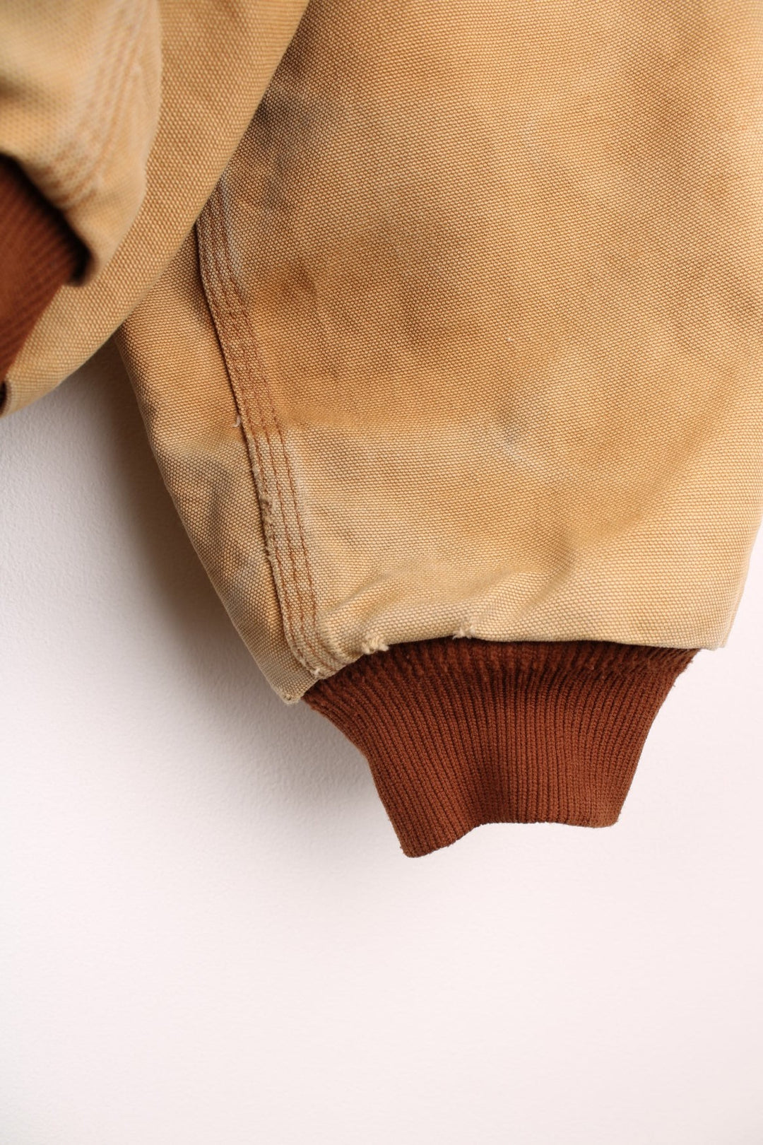 Carhartt Active jacket in tan with zip closure, brown trim and cuffs, an adjustable hood, double side pockets and a logo patch on the lower left. 