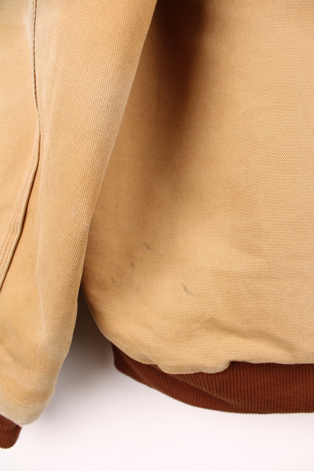 Carhartt Active jacket in tan with zip closure, brown trim and cuffs, an adjustable hood, double side pockets and a logo patch on the lower left. 