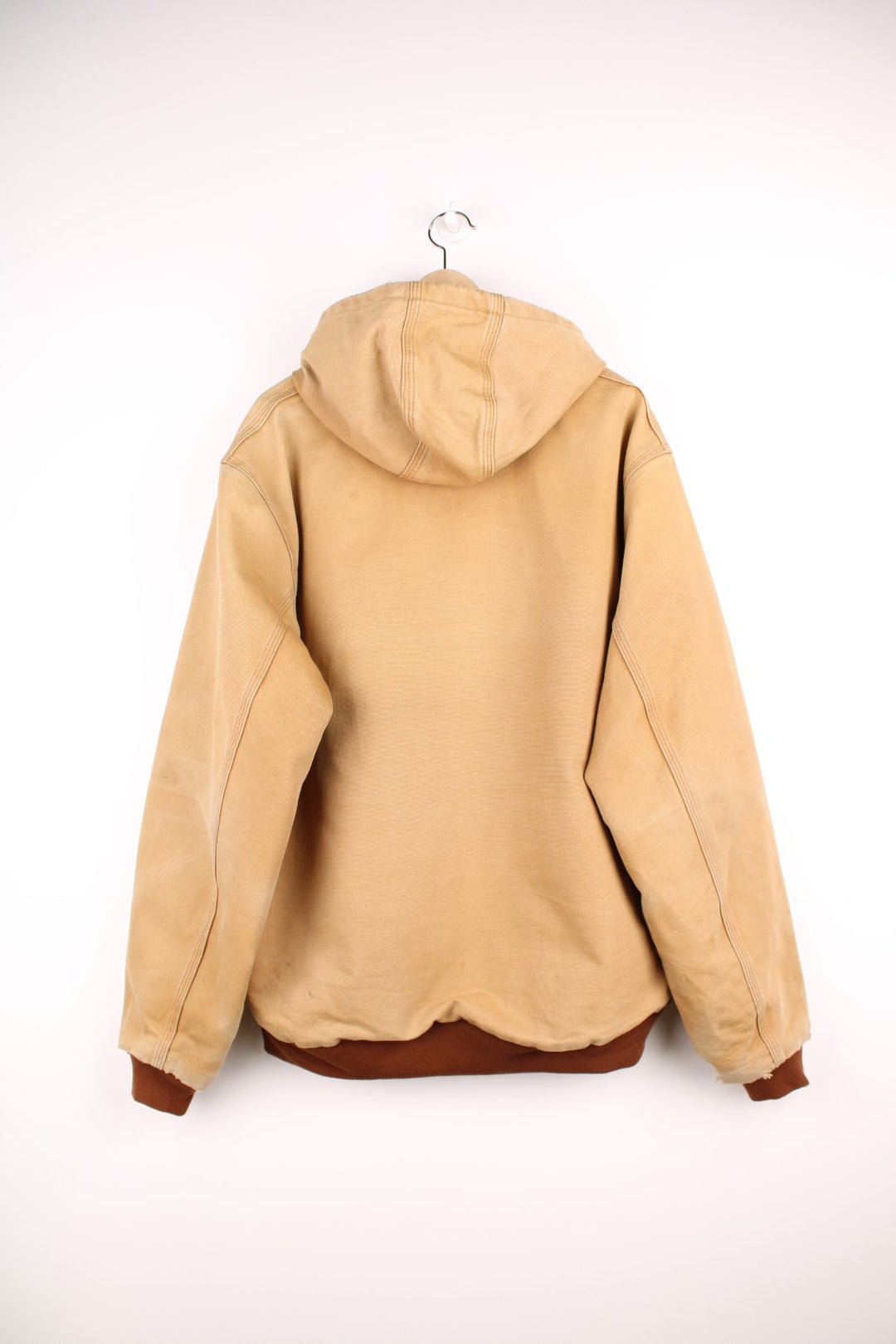 Carhartt Active jacket in tan with zip closure, brown trim and cuffs, an adjustable hood, double side pockets and a logo patch on the lower left. 