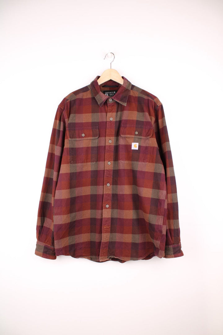 Carhartt burgundy check button through long sleeved shirt. Features chest pockets and embroidered logo. 