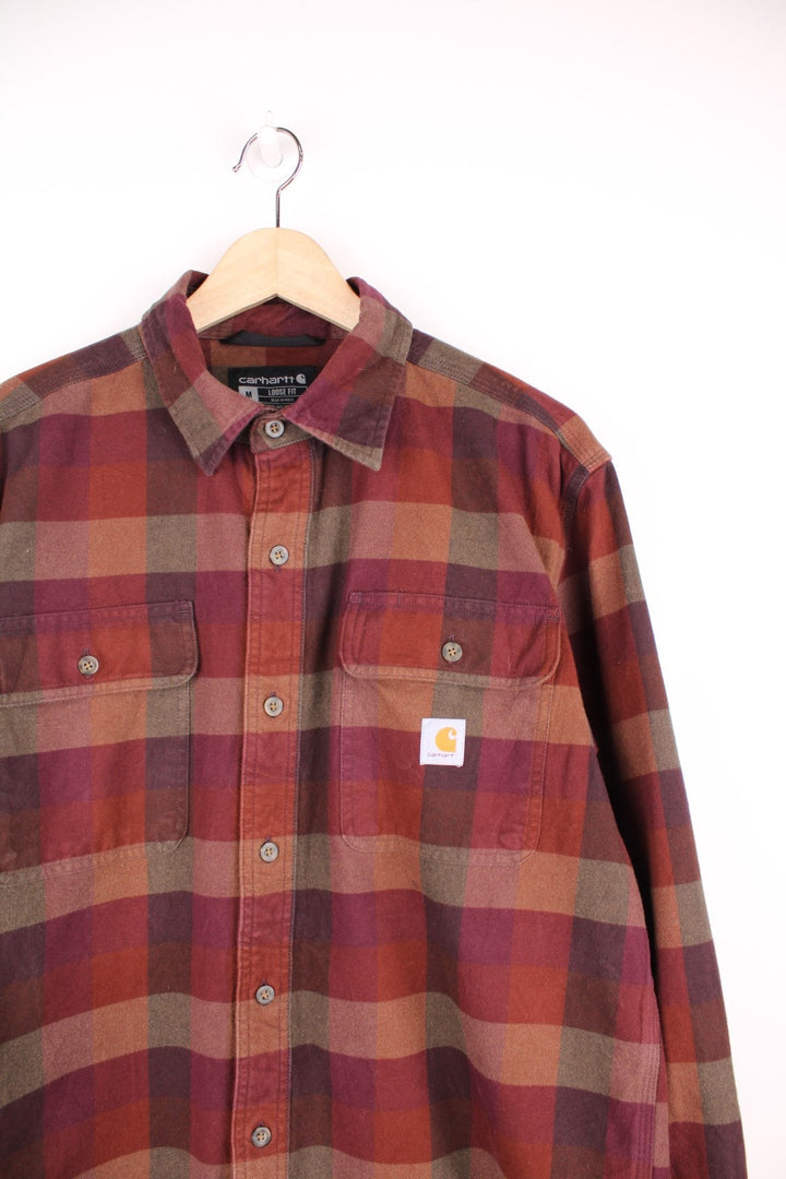 Carhartt burgundy check button through long sleeved shirt. Features chest pockets and embroidered logo. 