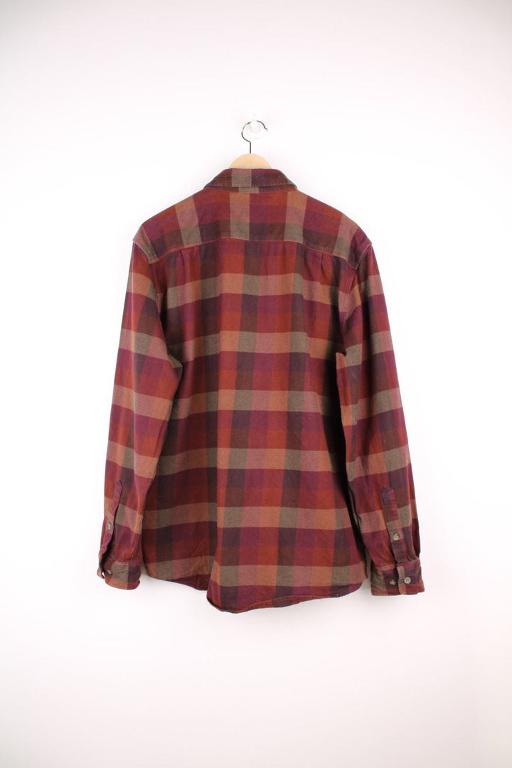 Carhartt burgundy check button through long sleeved shirt. Features chest pockets and embroidered logo. 