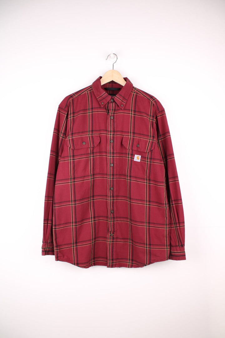 Carhartt red and beige button through plaid long sleeved shirt. Features chest pockets and embroidered logo. 