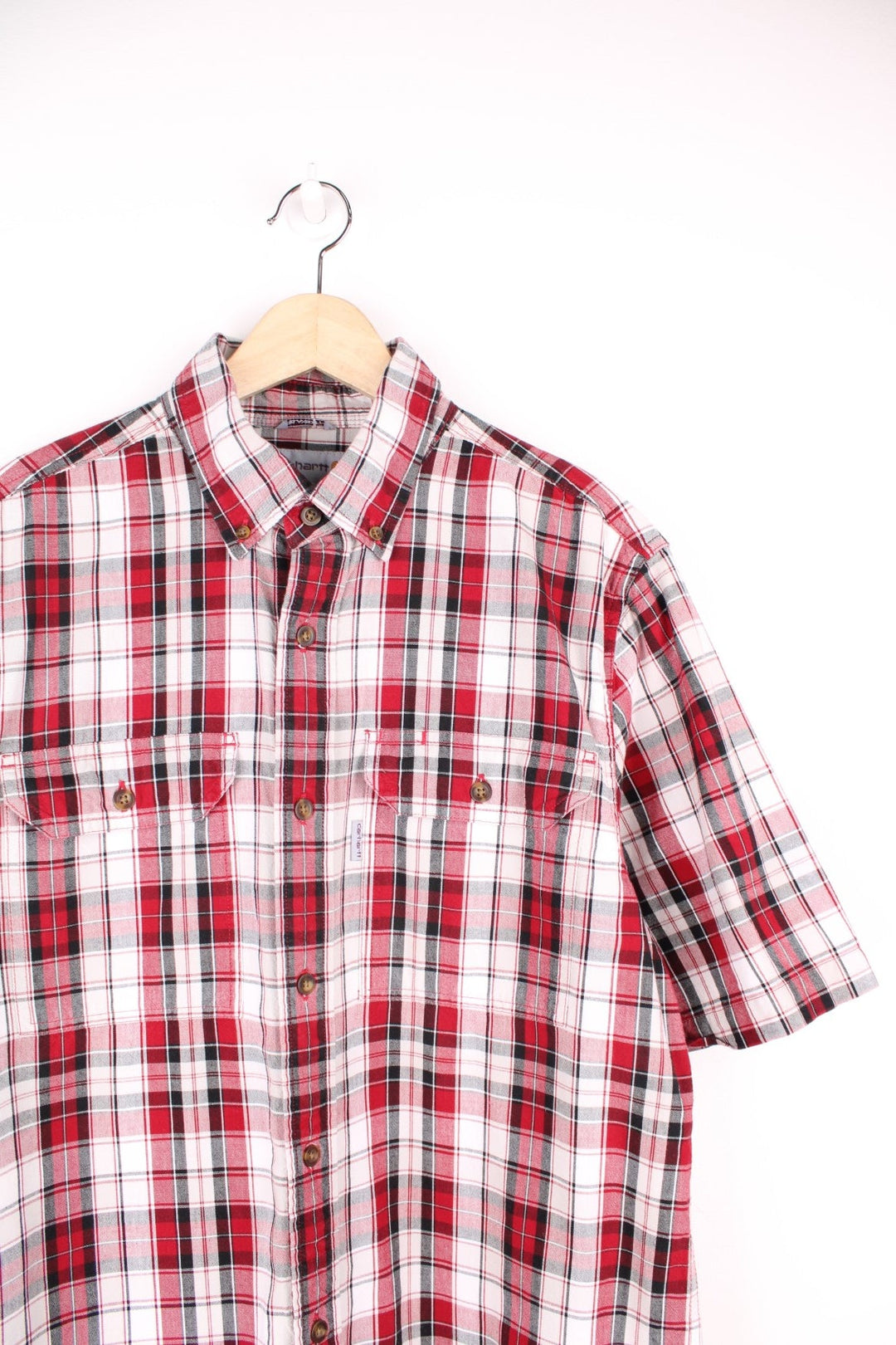 Carhartt red, white and black plaid button through shirt. Features chest pockets and embroidered logo. 