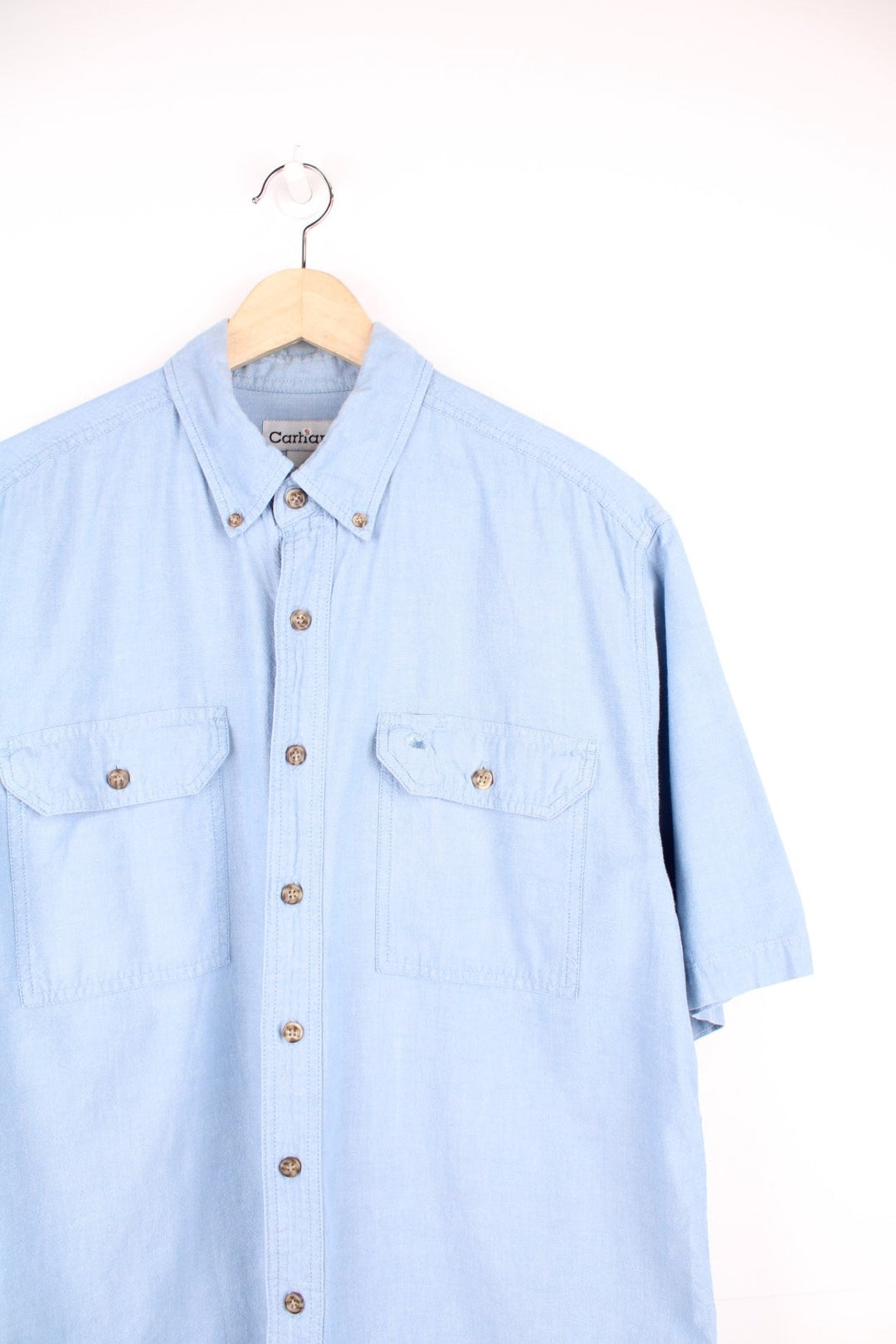 Carhartt blue button through shirt featuring chest pockets and C logo.