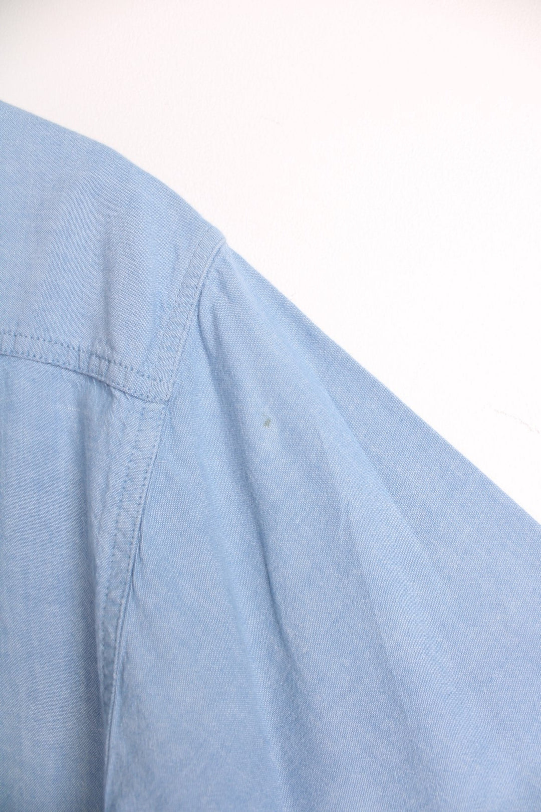 Carhartt blue button through shirt featuring chest pockets and C logo.