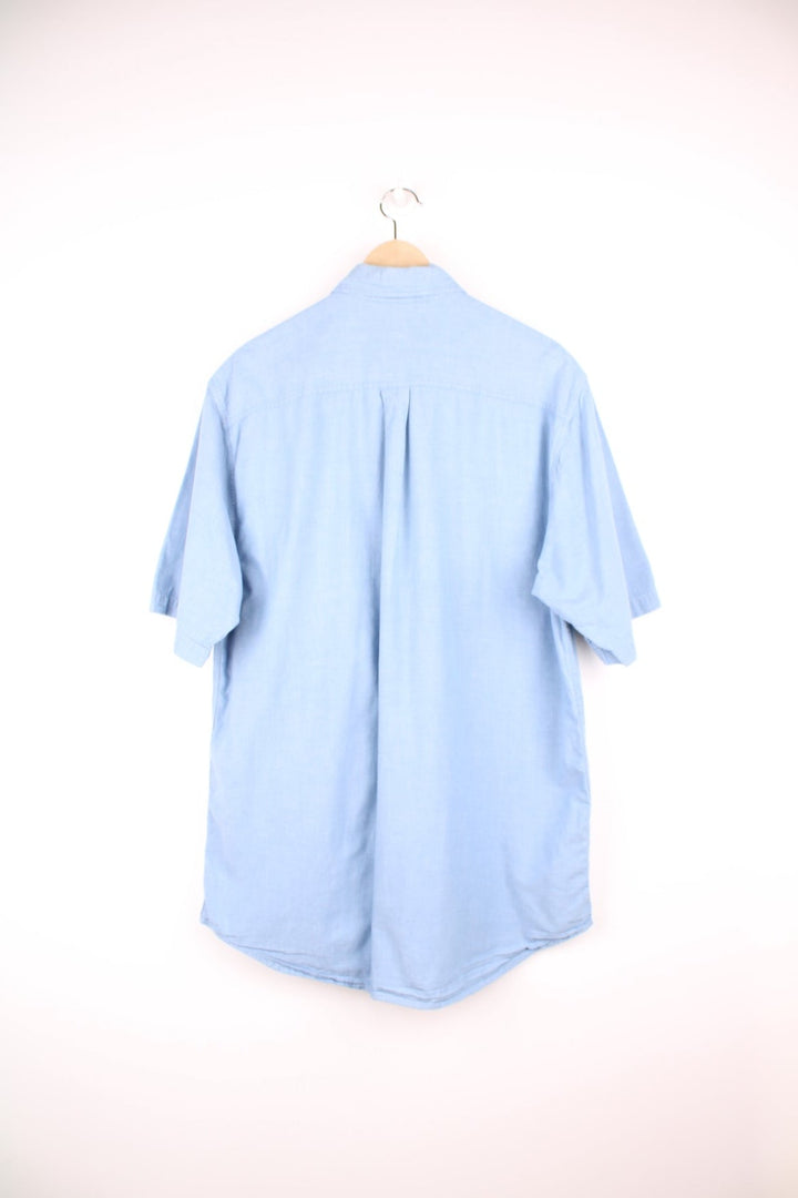 Carhartt blue button through shirt featuring chest pockets and C logo.