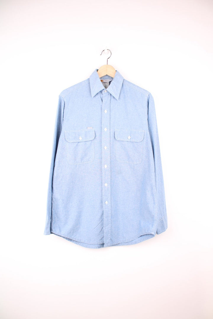 Carhartt blue button through long sleeved shirt with chest pockets and embroidered logo. 