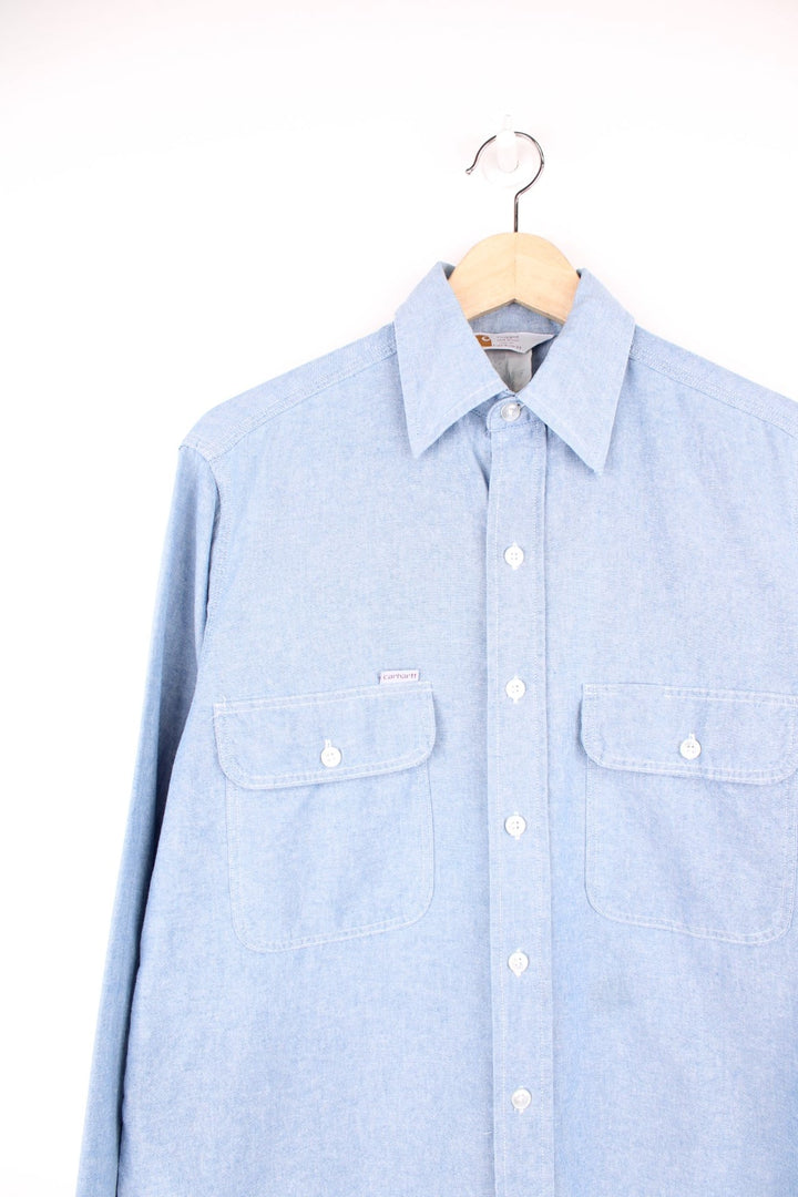 Carhartt blue button through long sleeved shirt with chest pockets and embroidered logo. 