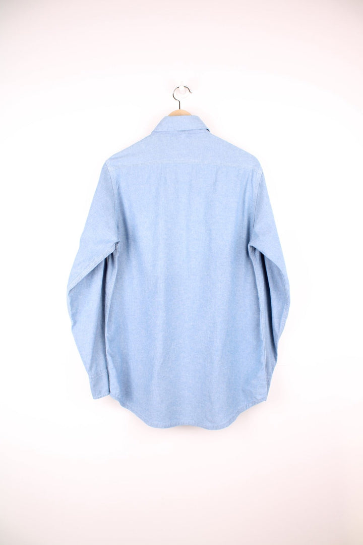 Carhartt blue button through long sleeved shirt with chest pockets and embroidered logo. 