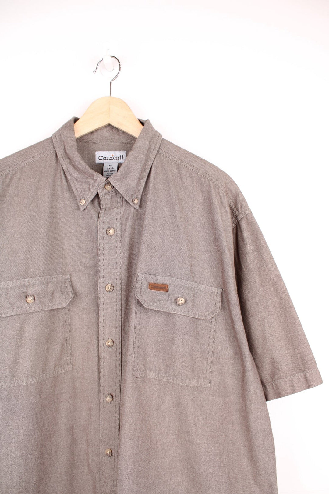 Carhartt khaki green button through shirt with chest pockets and embroidered leather logo.