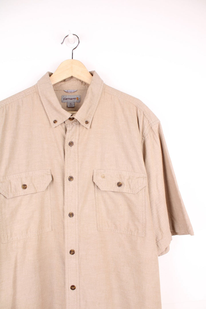 Carhartt Short Sleeve Shirt in a tanned colourway, button up, has double chest pockets and the logo embroidered on the front. 