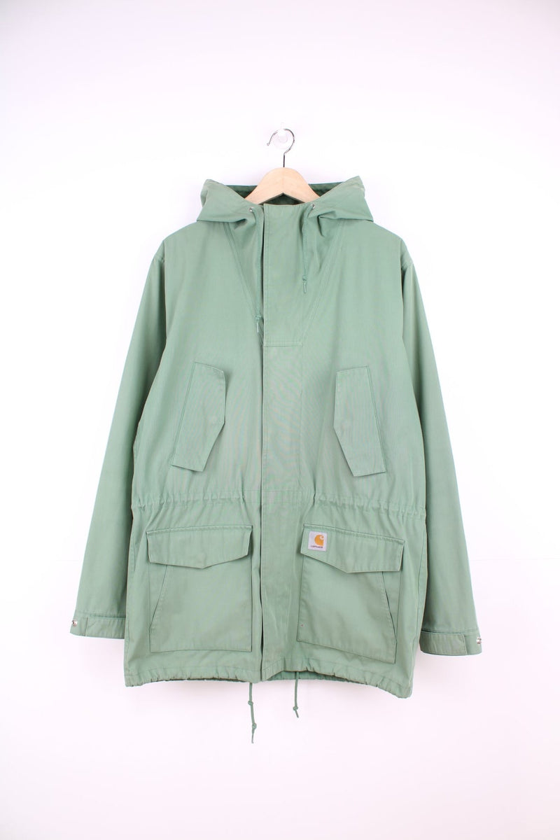 Carhartt Battle Parka Jacket in a green colourway, zip up with multiple pockets, hooded, and has the logo embrpidered on the front.