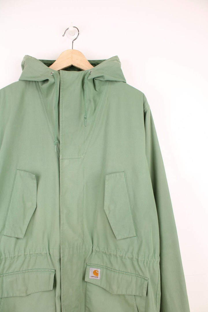 Carhartt Battle Parka Jacket in a green colourway, zip up with multiple pockets, hooded, and has the logo embrpidered on the front.