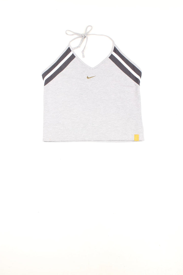 Nike grey tie-neck halter top with dark grey and white stripe detailing, Nike swoosh embroidered in gold, and a yellow spellout 'just do it' tag on the bottom left.